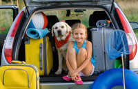Girl with dog and luggage