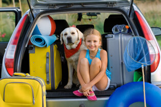 Girl with dog and luggage