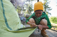 Kid helping set up camp