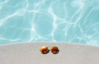 Sunglasses next to pool
