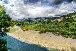 The river Drome of the Rhône-Alpes with hills in the background.
