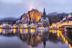 Church and cliff reflecting in river Meuse, Dinant