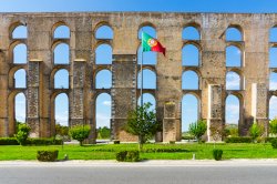 Amoreira Aqueduct and flag of Portugal in Elvas. Alentejo, Portugal.