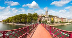 Pedestrian Saint Georges footbridge and the Saint Georges church in Lyon