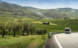 Motorhome driving among Tuscan vineyards