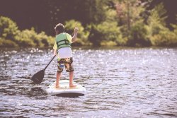 a boy paddleboarding