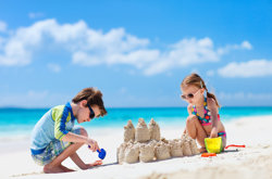 Kids on beach building sandcastles